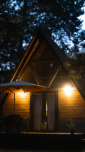 istock Cabin architecture with warm lights in the night. 2252580745