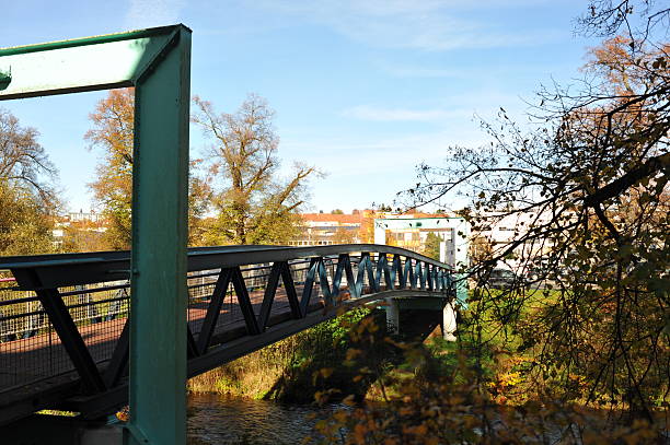 istock Peaceful terrace decorated with autumn leaves, Quiet cafe setting by river with autumn decor and sunlight 2252581226