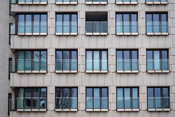 istock Modern residential building facade with rhythmic windows and glass balconies in dense contemporary urban housing architecture environment 2252581320