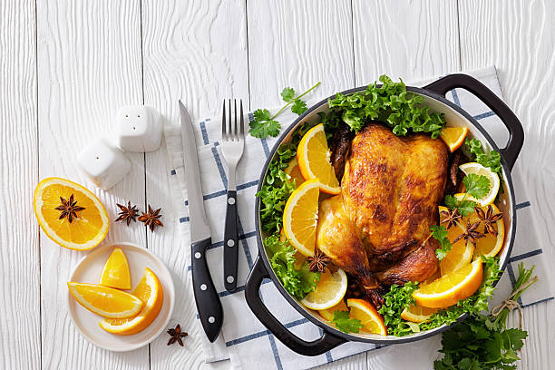 istock Whole roasted chicken in baking dish with citrus 2252581802