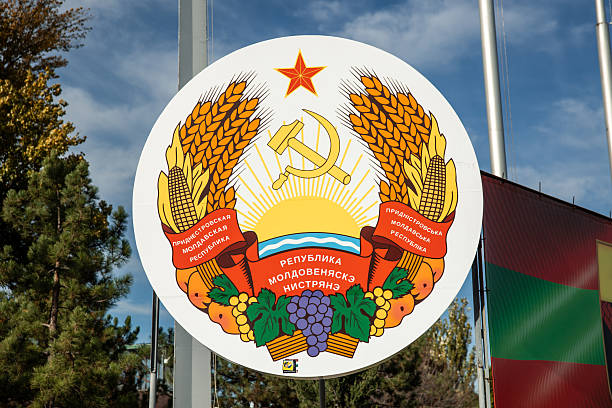 November 12, 2025, Moldova. Transnistrian coat of arms, a symbol reflecting the unrecognised state's Soviet heritage, is seen outdoors under a blue sky, representing its unique political identity