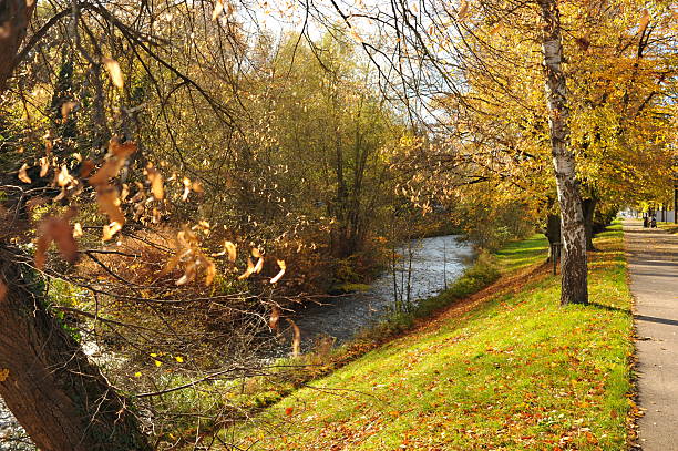 istock Serene nature scene, Scenic walkway beside gentle river with lush greenery and peaceful atmosphere 2252584955