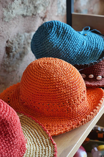 istock Colorful handmade hats displayed on wooden shelf 2252586708