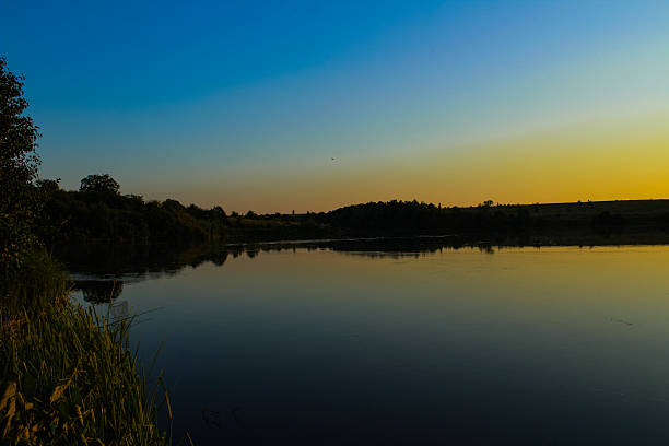 Warm sunlight reflections on the river at dusk, capturing the essence of peace and inspiration