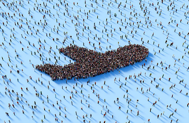 Human crowd forming airplane symbol on blue background.