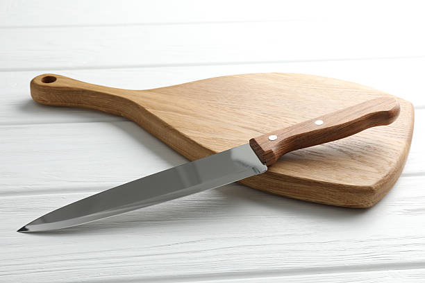 istock One sharp knife on white wooden table, closeup 2252592455