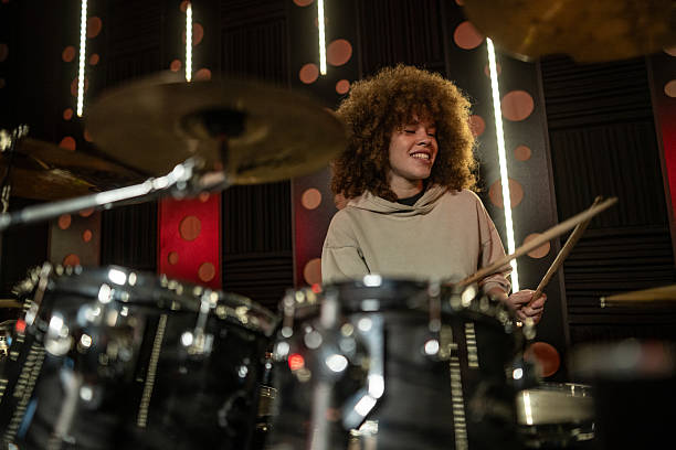 istock Woman drummer playing drums in music studio 2252592645