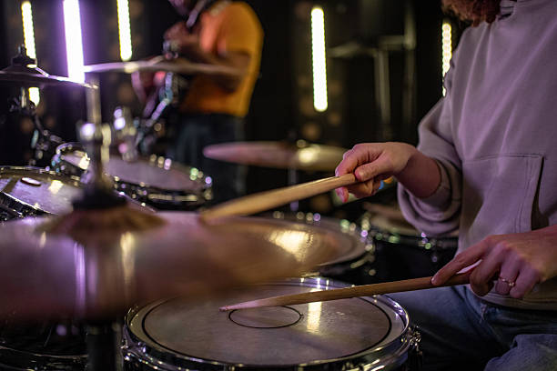 istock Drummer playing drums during music band rehearsal 2252592998