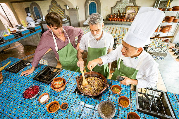Asian Indian Chef preparing taco Mexican food in kitchen