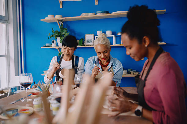 istock Multicultural Group of Women Making Pottery and Drinking Wine in Creative Workshop 2252601775
