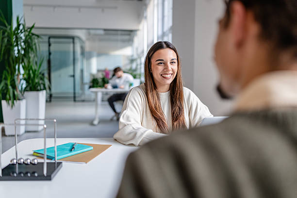 istock Team members engage in conversation at a modern office during work hours with focus on collaboration and productivity 2252602625