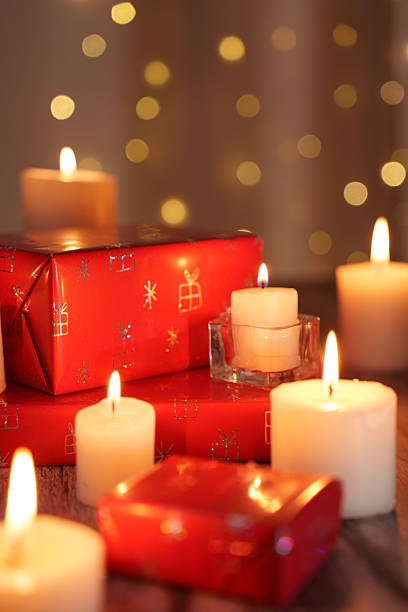 istock festive ambiance with glowing candles surrounding red gift boxes against a soft bokeh background, creating a warm and inviting holiday spirit with a touch of elegance and joy, winter, vintage 2252603232