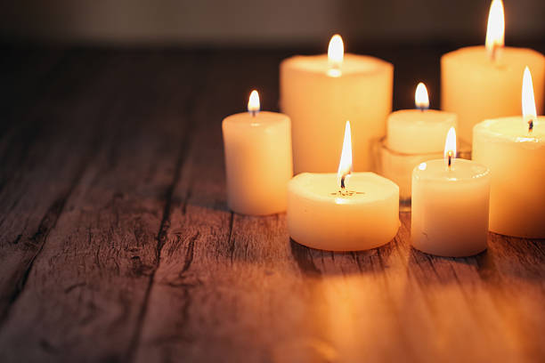 istock warm glow of assorted lit candles on rustic wooden surface creating a serene ambiance with soft shadows and gentle flickering light in a cozy setting, decor, aura, simple, zen, intimate, meditation 2252603246