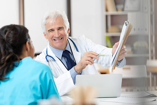 istock Doctor reviewing medical chart with patient while smiling 2252603854