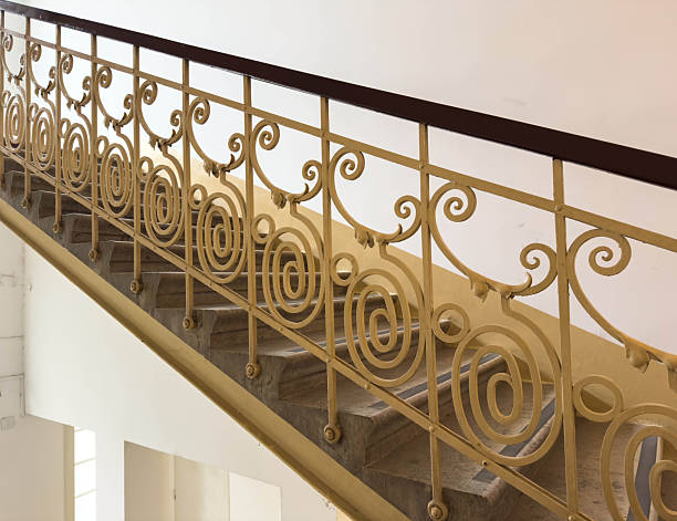istock Elegant spiral wrought iron staircase railing in historic building interior 2252604459