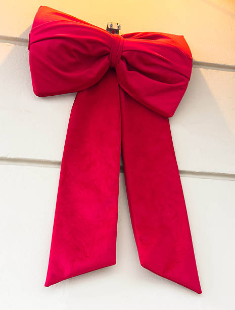 istock Large red christmas bow on green wreath 2252605171
