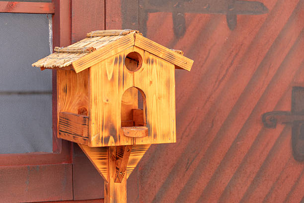 Birdhouse on a string hanger - studio shot with a white background