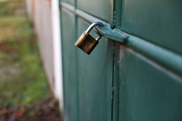 Rusty Padlock on a Green Gate
