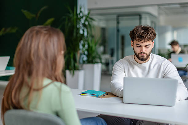 istock Workers engage in discussion in a modern office environment with technology and collaboration among colleagues 2252606193