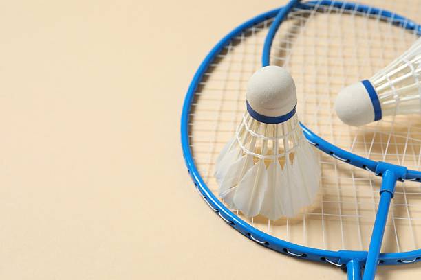 istock Badminton rackets and white badminton shuttlecocks on color background 2252606236