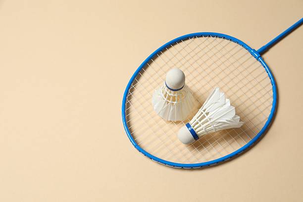 istock Badminton rackets and white badminton shuttlecocks on color background 2252606435