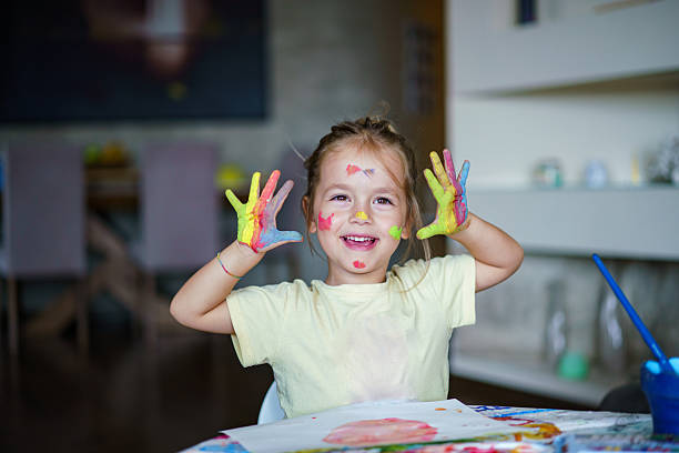 istock Happy child showing colorful painted messy hands. 2252607385