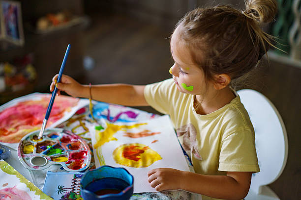 istock Young child learning and creating watercolor art. 2252607546