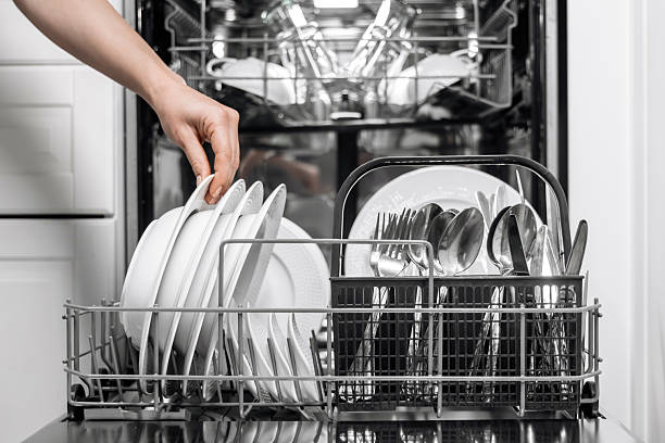 istock Dishwasher loaded with clean white plates and glasses 2252609290