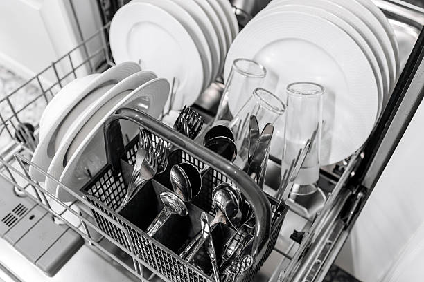 istock Dishwasher loaded with clean white plates and glasses 2252609420