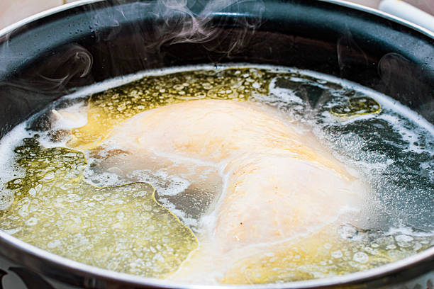 istock preparing delicious chicken broth in a silver pan in the home kitchen. an ingredient for further preparation of soup. light rich broth is good for the diet 2252609652