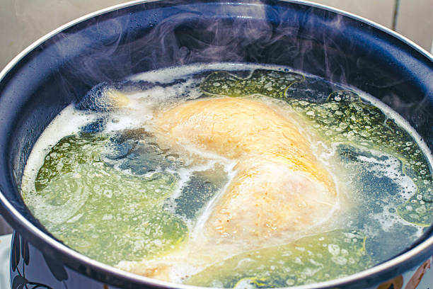 istock preparing delicious chicken broth in a silver pan in the home kitchen. an ingredient for further preparation of soup. light rich broth is good for the diet 2252609655