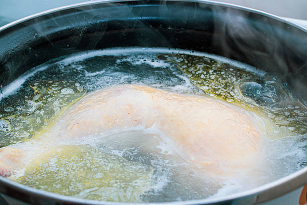 istock preparing delicious chicken broth in a silver pan in the home kitchen. an ingredient for further preparation of soup. light rich broth is good for the diet 2252609656