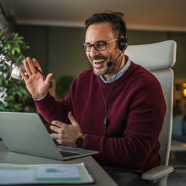 istock Man in headset having online video call from home office 2252609867