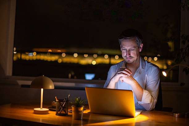 istock Man working late at night in home office 2252611062