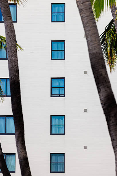 istock Rows of square windows in a white-walled building 2252614636