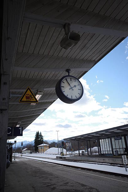 istock Train station with a clock hanging from the ceiling 2252616056