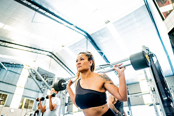 istock Mature woman doing squat exercises at gym 2252616343