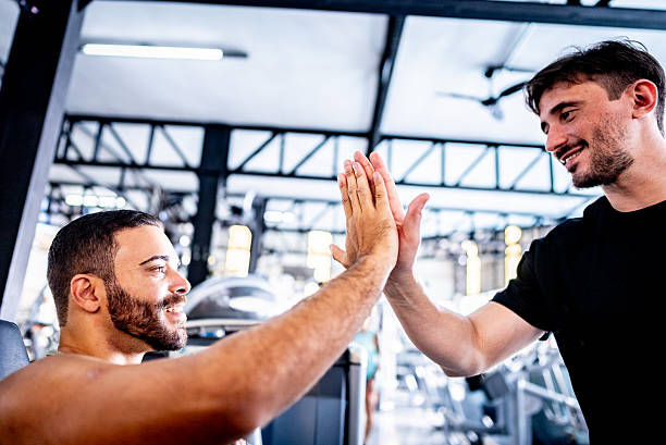 istock Trainer and student doing high-five at the gym 2252616690