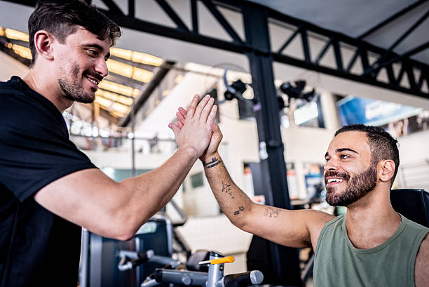 istock Trainer and student doing high-five at the gym 2252616693