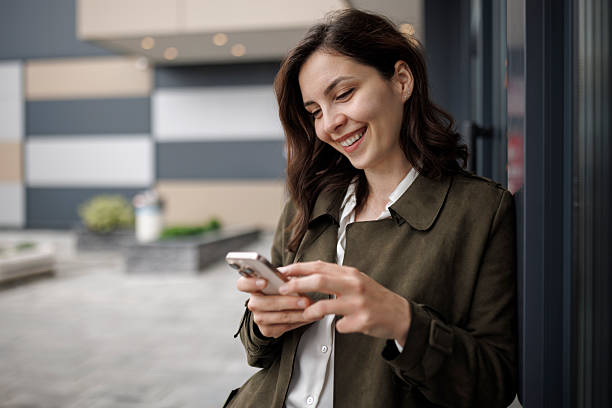 istock Young Businesswoman Texting Outside Office 2252616921