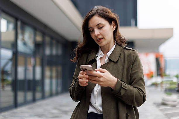istock Woman Using Smartphone Outdoors 2252617045