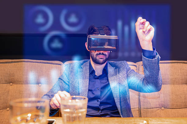 Young engineer wearing VR headset,  Businessman using Futuristic Hologram Technology