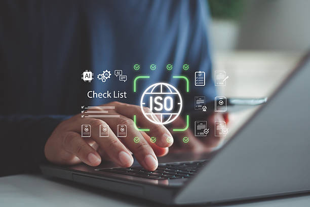 istock Businessman working on laptop with ISO certification checklist, compliance documents, quality management system. AI technology icons. Standardization, audit, corporate governance, digital workflow. 2252620659