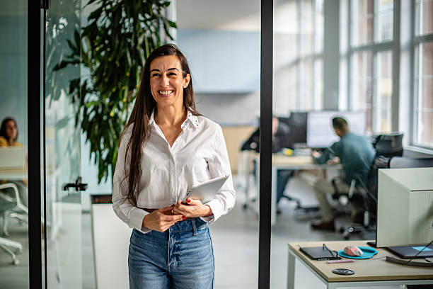 istock Workers collaborate in a modern office space during the day with a focus on teamwork and technology 2252627018