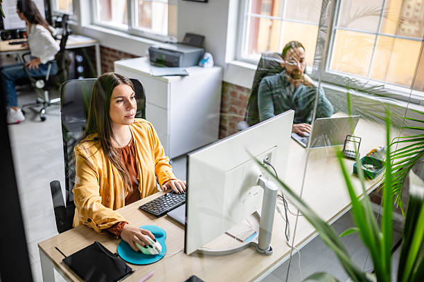 istock Young professionals work at desks in a modern office space during the day in a collaborative environment 2252627358