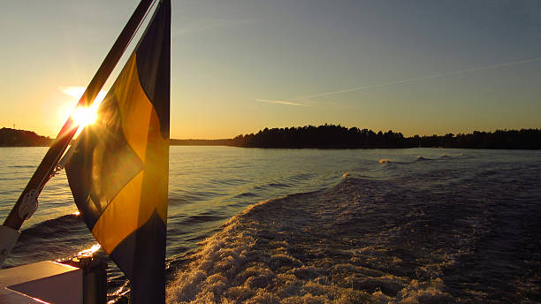 Swedish Flag on Back of Boat at Sunset