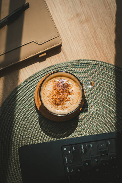Gourmet cappuccino in dramatic natural sunlight with deep shadows.