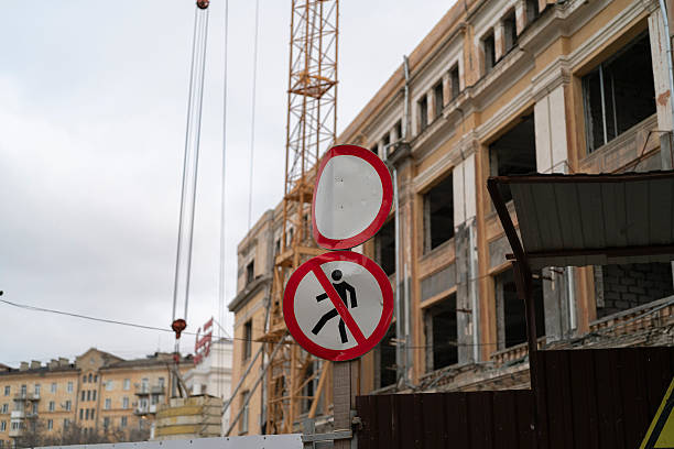 istock Construction continues on a building with a sign warning about falling objects above the site 2252633345