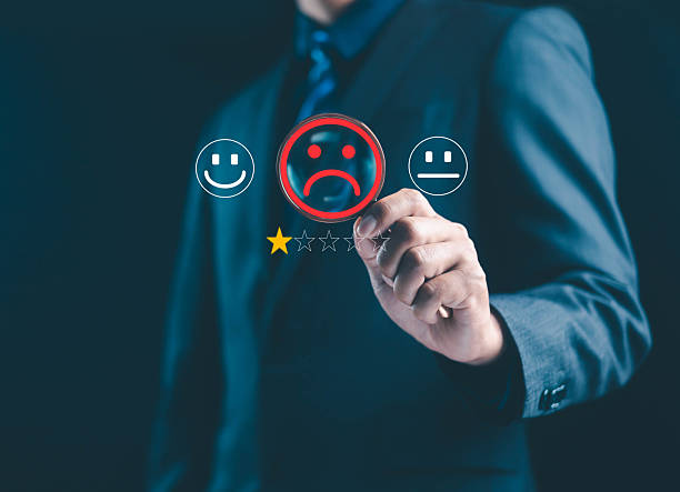 istock businessman selecting a negative rating with sad emoticons represents poor customer experience, feedback evaluation, and service dissatisfaction, highlighting the importance of review management. 2252642830