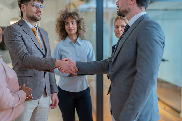 istock Business people shaking hands in modern office 2252643396